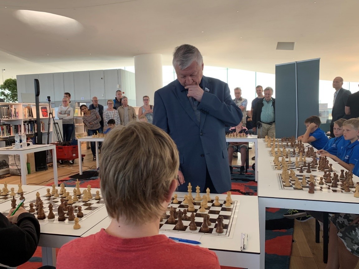 Anatoly Karpov contemplating a move against a young opponent in Helsinki, Finland. 